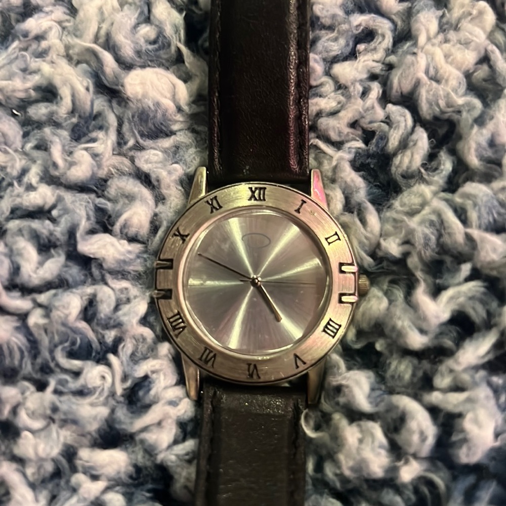 Parfums black leather band and silver watchhead (batteries not included)